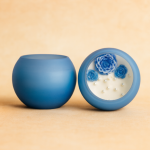 Bloom Aura Lavender Candle in a frosted blue glass bowl featuring hand-crafted blue rose decorations and pearl accents, made with natural soy wax and a cotton wick.